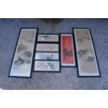 A collection of 20th century oriental paintings on silk in black frames of varying scenes and sizes,