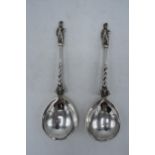 A pair of ornate Victorian silver spoons, London 1874, 126.1 grams. 19.5cm long.