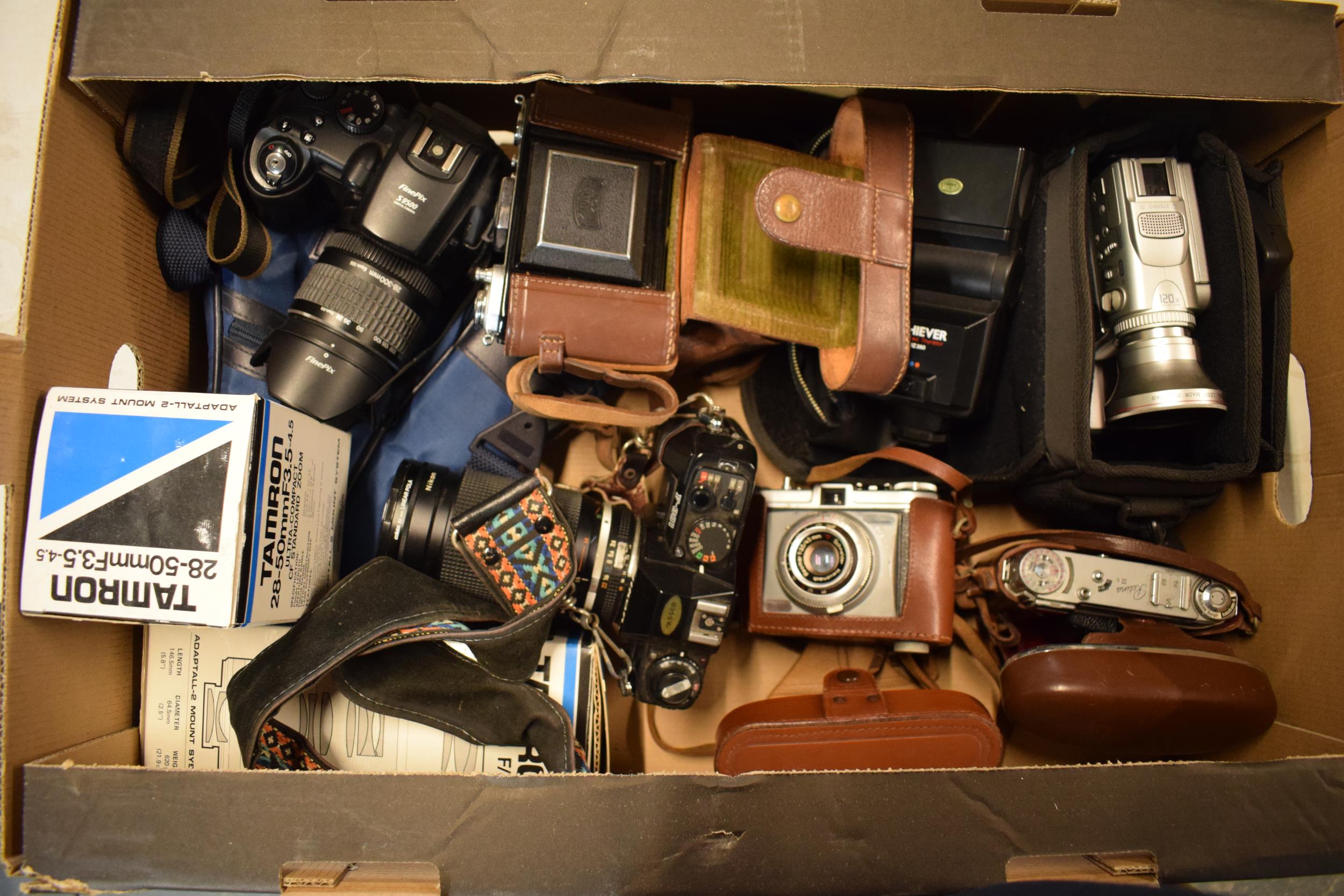 A collection of cameras and camera equipment to include FinePix S9500, Nikon F-301, Retina III, Sony