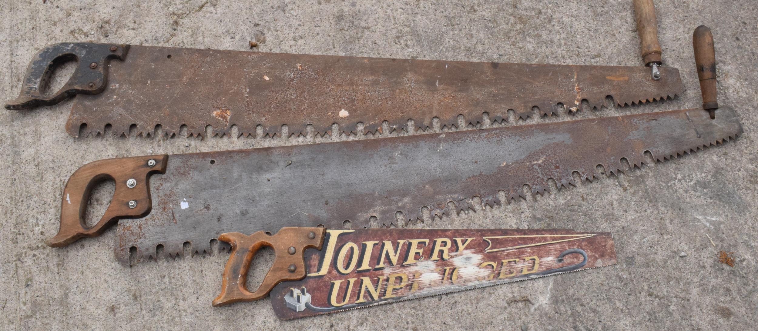 A trio of vintage wooden and metal saws to include two two-man saws and small painted example (3),