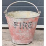 Vintage metal fire bucket with swing-over handle painted red with 'FIRE' in black, 28cm tall with