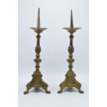 A pair of late 19th century Ecclesiastical brass baluster form candlesticks with each terminating on