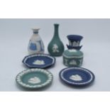 A collection of Wedgwood Jasperware to include vases, a trinket and pin dishes of varying colours