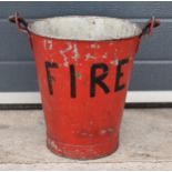 Vintage metal fire bucket with swing-over handle painted red with 'FIRE' in black, 33cm tall with