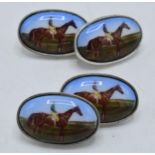 A pair of silver and enamel cufflinks decorated with jockeys (2).