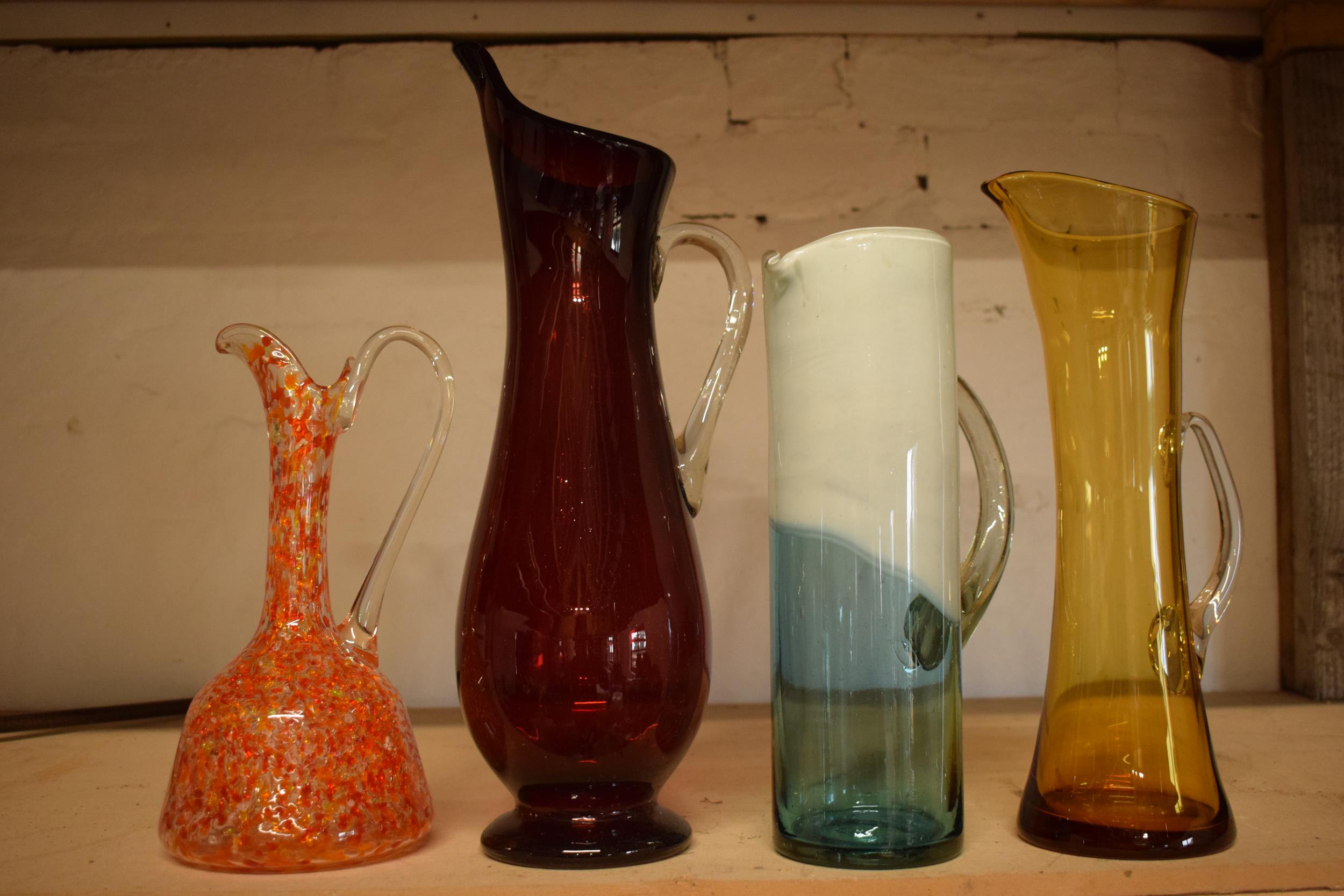 A collection of assorted art / studio glass in the form of jugs (4), tallest 44cm. Condition is