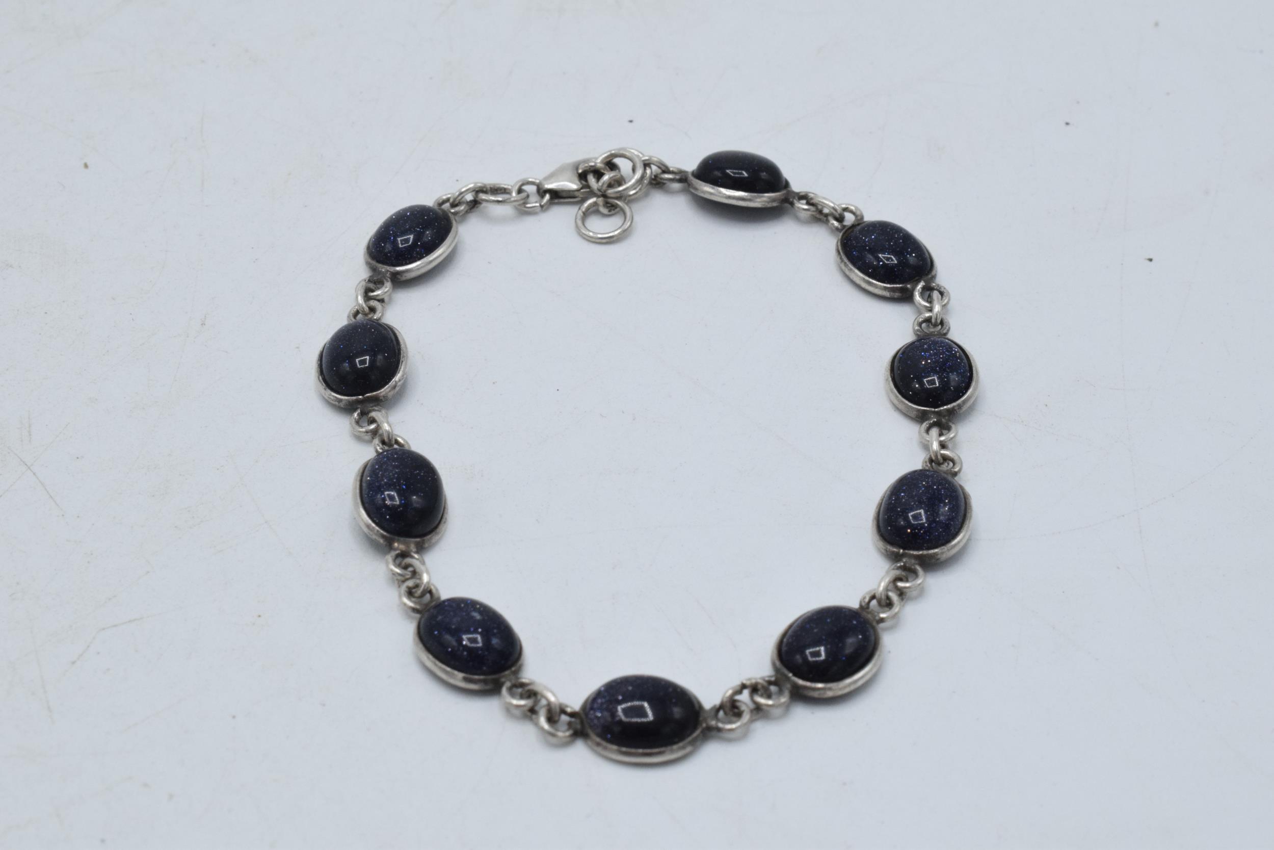 Silver ladies bracelet with blue insets, 20cm long. 7.6 grams.