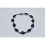 Silver ladies bracelet with blue insets, 20cm long. 7.6 grams.