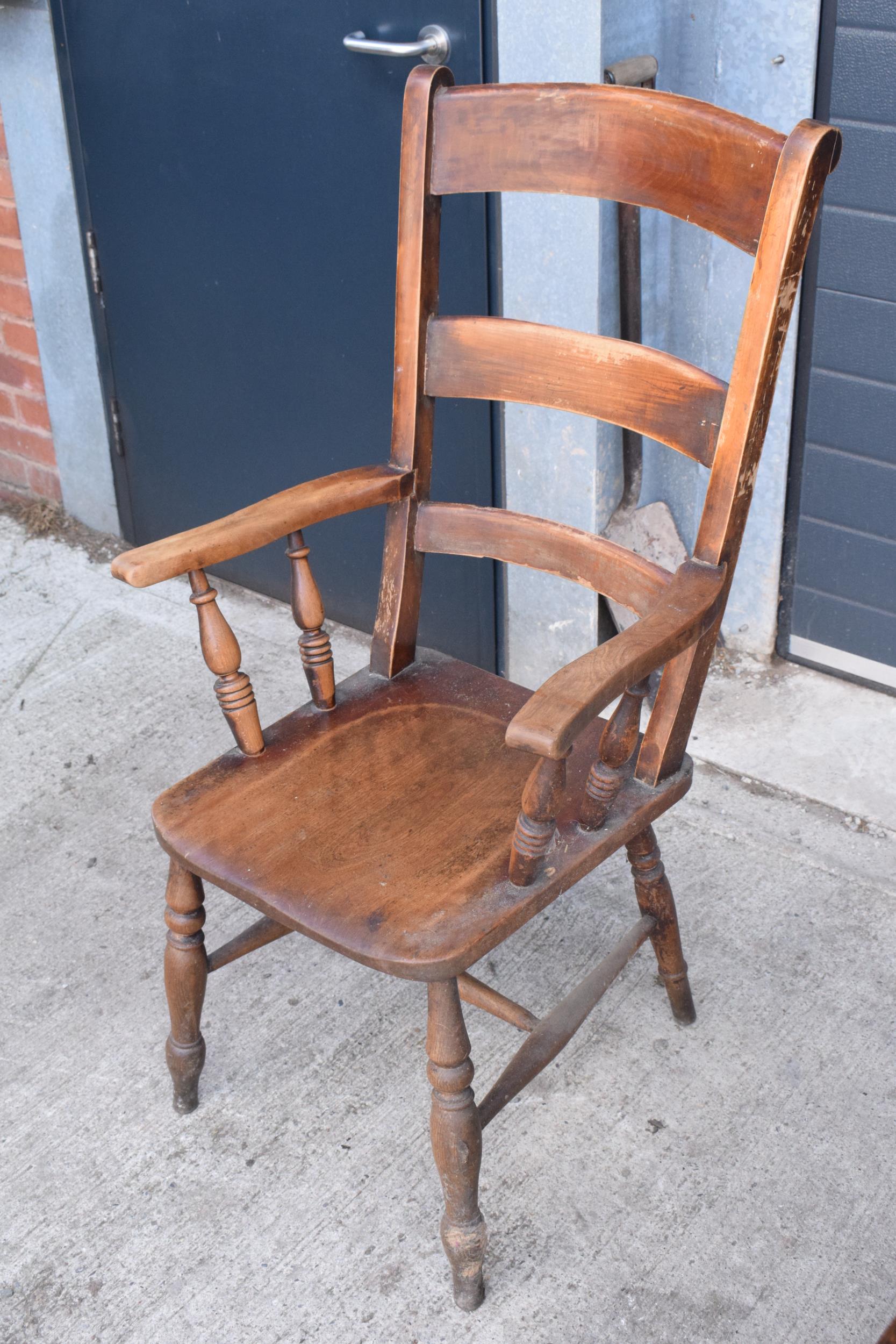 Victorian wooden farmhouse armchair, 112cm tall. Age-related wear and scuffs to include scratches