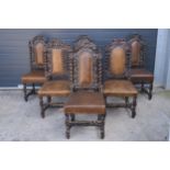 A near set of 6 Edwardian dining chairs with brown leather upholstered seats and carved wooden backs