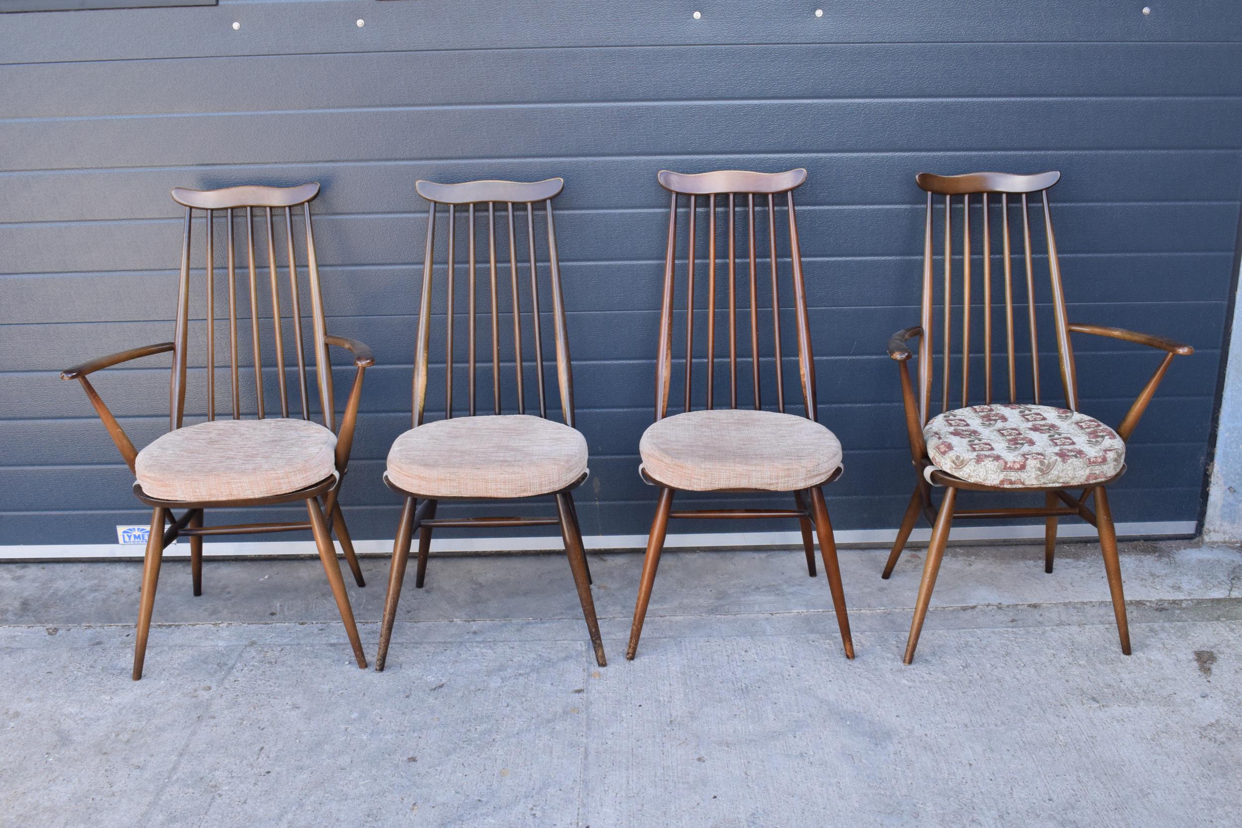 A set of 4 mid century Ercol spindle-back chairs to include 2 arm chairs (4). 97cm tall. Age-related