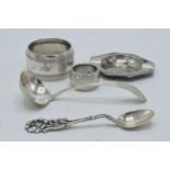 A collection of continental silver items to include small ashtray, napkin rings, a spoon and one