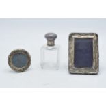 A trio of silver items to include silver-topped scent bottle and 2 silver fronted frames (3).