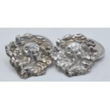 A pair of Silver cufflinks with maidens head amongst foliage (2).