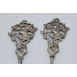 A pair of silver plated meat skewers with stag's heads amongst foliage, 22.5cm long (2).