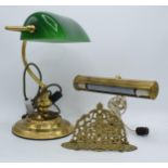 A brass bankers lamp with green glass shade together with a similar brass example and a letter