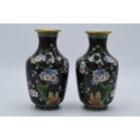 A pair of Japanese cloisonne vases with floral decoration on a black background, 15.5cm tall,