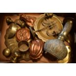 A collection of metalware to include brass and copper items such as jelly mould, brass trays,