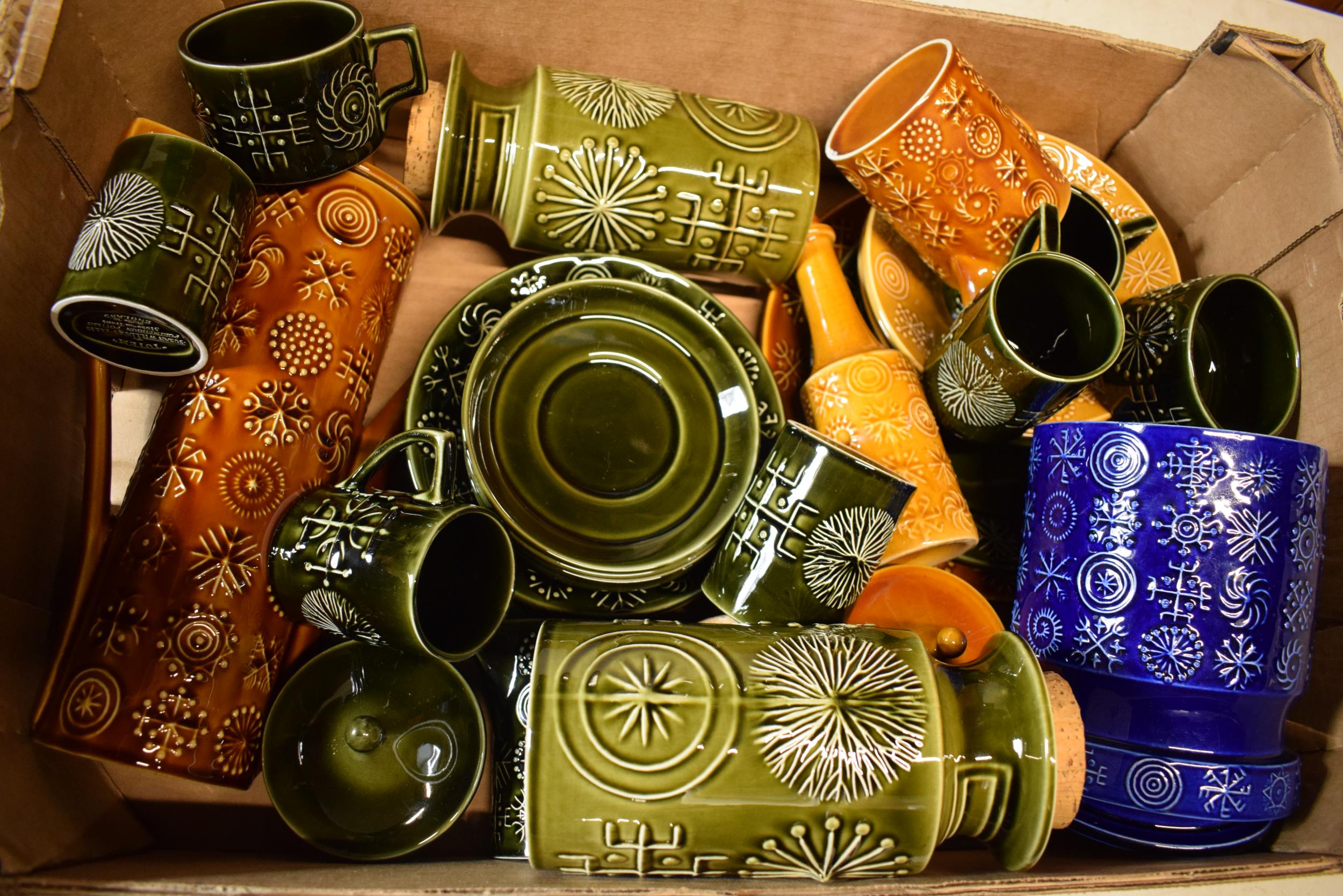 A collection of Portmeirion pottery in the Totem pattern in varying colours and forms to include