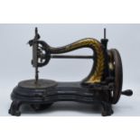 Antique hand-propelled Jones & Company hand sewing machine, 38cm long.