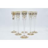 A set of 6 tall glass champagne flutes with swirl, gilt and stone-like decoration (6), 24cm tall. In
