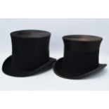 A pair of black gentleman's top hats, one 'Best Quality London, opening 18x15cm, and the other