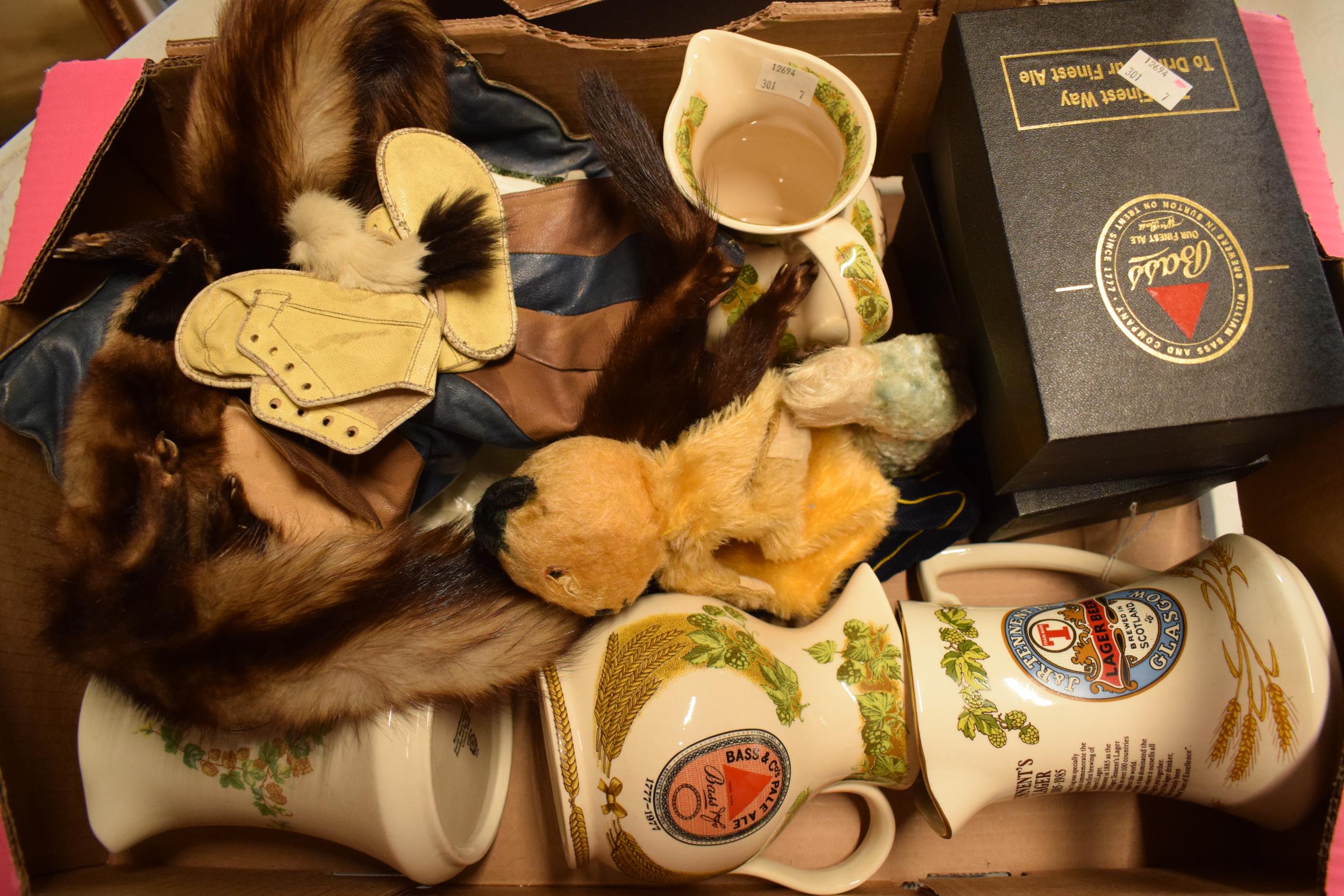 A collection of items to include Bass pub jugs, 1950s Sooty hand puppet, mink stoles and others.