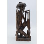 20th century Eastern wooden tribal-style carving of a water carrier / fisherman, 31cm, signed '