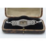Platinum and diamond ladies wristwatch, in original box, in ticking order, 19.6 grams gross weight.