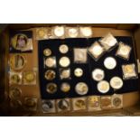 A collection of gold and silver plated commemorative coins of varying forms and sizes (approx 35).