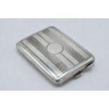 Hallmarked silver slimline cigarette / card case with engineered decoration, 33.8 grams, 6.5cm long.
