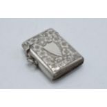 Hallmarked silver vesta case with shield cartouche amongst foliage, Birmingham 1904, 16.0 grams.