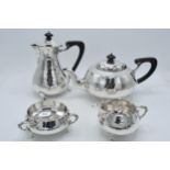 Hallmarked silver four piece tea set with ebonised handles and finials to consist of a teapot,