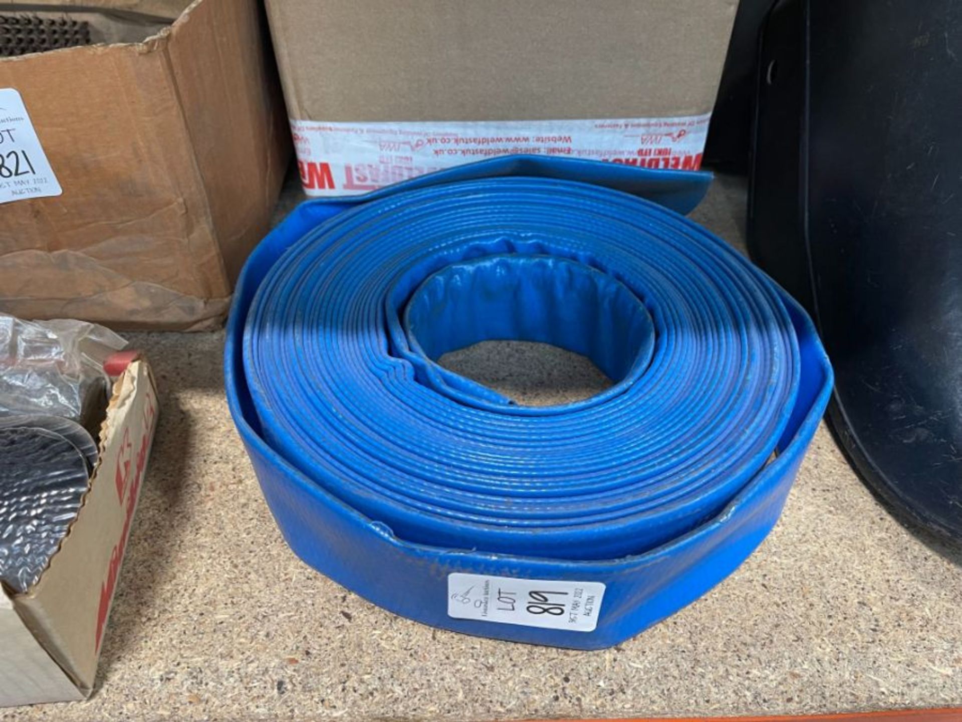 A LENGTH OF FLAT BLUE RUBBER HOSE