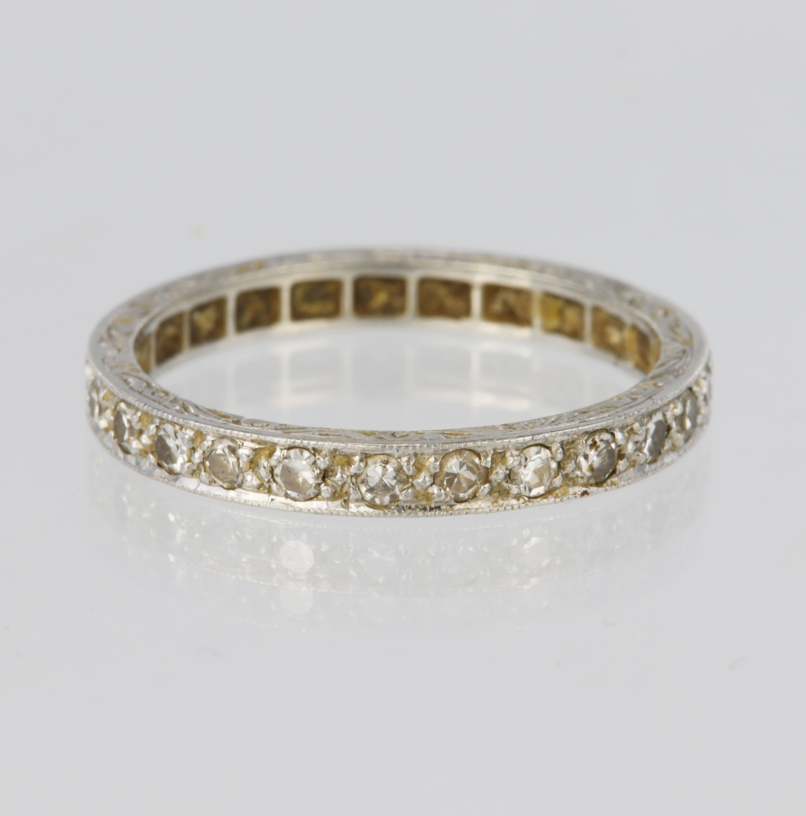 Platinum full eternity ring set with twenty five round brilliant cut diamonds in grain settings,