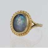 9ct yellow gold ring set with a single oval opal doublet measuring approx. 11mm x 9mm with a rope