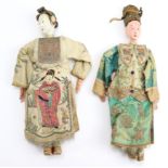 Two Chinese dolls, circa 19th Century, in traditional dress with silk decoration, both with