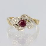 9ct yellow gold crossover style ring set with a central ruby measuring approx. 4mm diameter with a