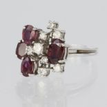 18ct white gold dress ring featuring four oval rubies, three measuring approx. 5mm x 4mm and one