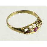 18ct yellow gold boat shaped ring set with three graduated rubies and two diamonds, total diamond