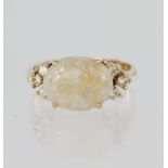14ct yellow gold ring featuring an oval opal cabochon measuring approx. 12mm x 8mm with three