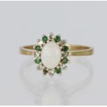 9ct yellow gold cluster ring featuring a central oval opal measuring approx. 6mm x 5mm, and