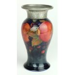 Moorcroft. Blue pomegranate vase with the hammered finish pewter rim. Signed and stamped to base.