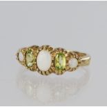 9ct yellow gold graduated five stone ring set with three opals cabochons and two faceted peridot,