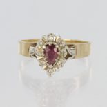 9ct yellow gold ring set with a central pear shaped ruby measuring approx. 6mm x 4mm and