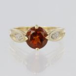 9ct yellow gold ring set with round hessonite garnet measuring approx. 8mm diameter, with three