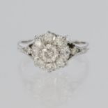 18ct white gold cluster ring featuring nine round brilliant cut diamonds and a further diamond to