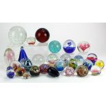Glass paper weights. A collection of approximately twenty-five glass paperweights, largest diameterc