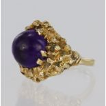 9ct yellow gold dress ring set with a round amethyst cabochon measuring approx. 10mm diameter, set