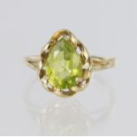 9ct yellow gold ring set with single pear cut peridot measuring approx. 10mm x 8mm in a claw setting